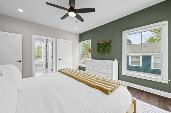 a bedroom with a large bed and a chandelier