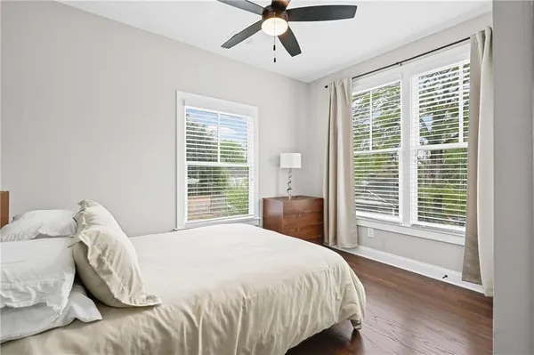 a large bed sitting in a bedroom next to a window