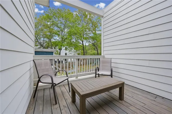 a view of a deck with wooden floor and outdoor seating