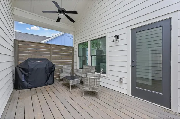 a view of a deck with wooden floor and floor to ceiling window