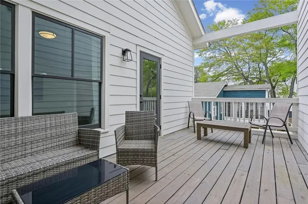 a view of balcony with wooden floor and outdoor seating