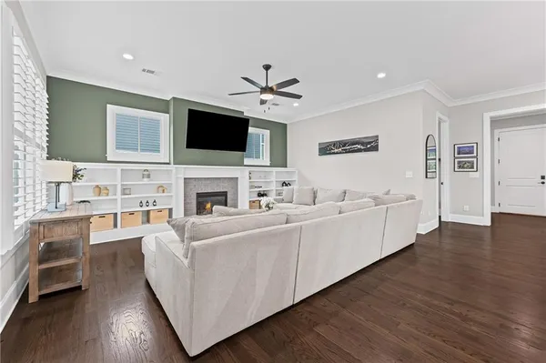 a living room with furniture fireplace and flat screen tv