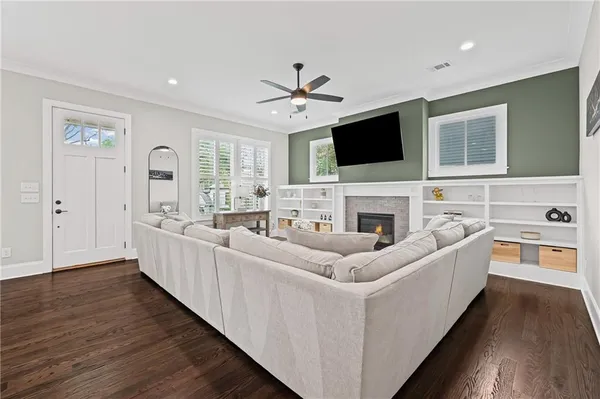 a living room with furniture fireplace and a flat screen tv