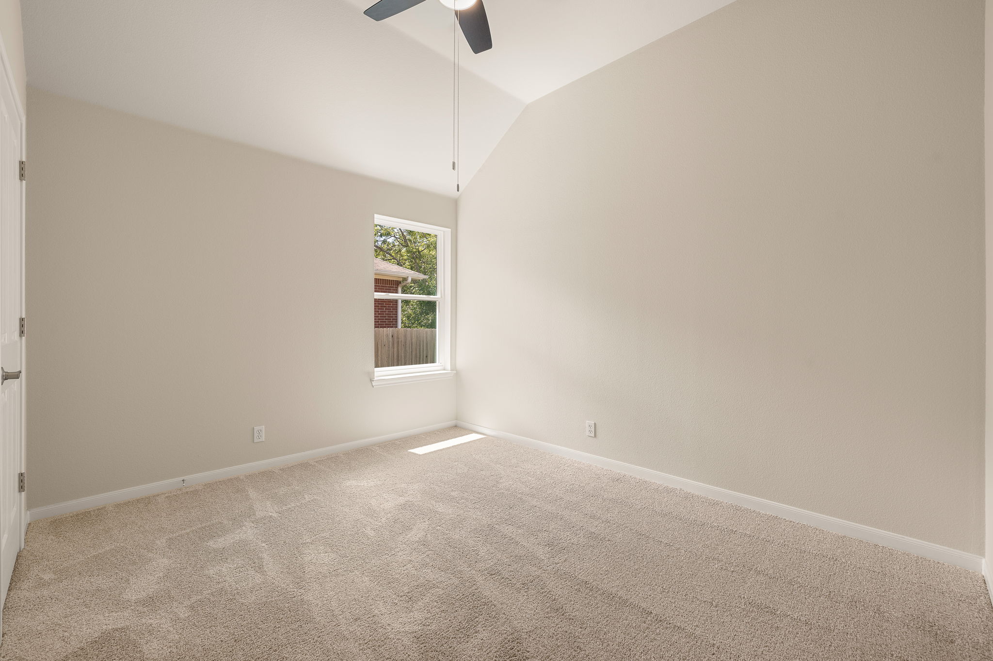 1100 Springbrook Road Pflugerville, TX 78660 - Photo 18 of 23 A spacious room offers comfortable carpet flooring and a refreshing ceiling fan for relaxation.