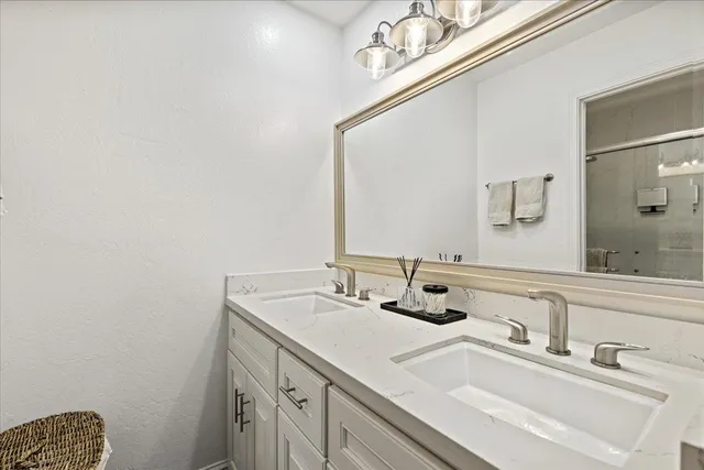 a bathroom with a sink vanity and a mirror