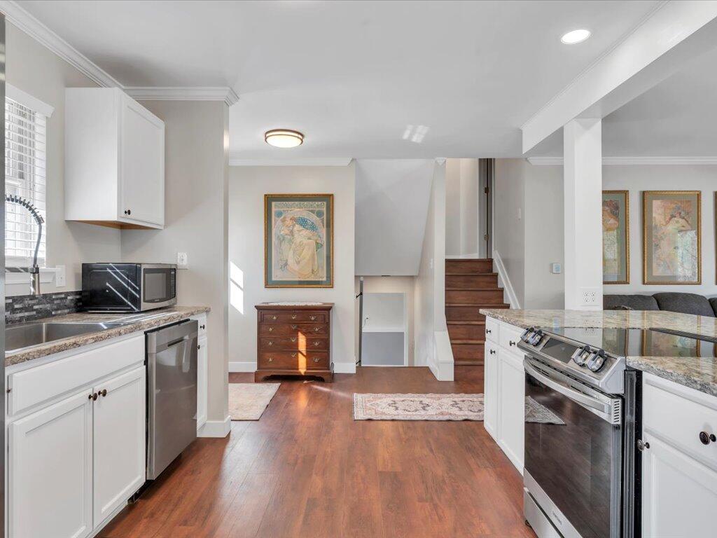 1511 Eggleston Falls Road Ridgeway, VA 24148 - Photo 13 of 151 a kitchen with stainless steel appliances granite countertop a stove top oven a sink dishwasher and a refrigerator with wooden floor