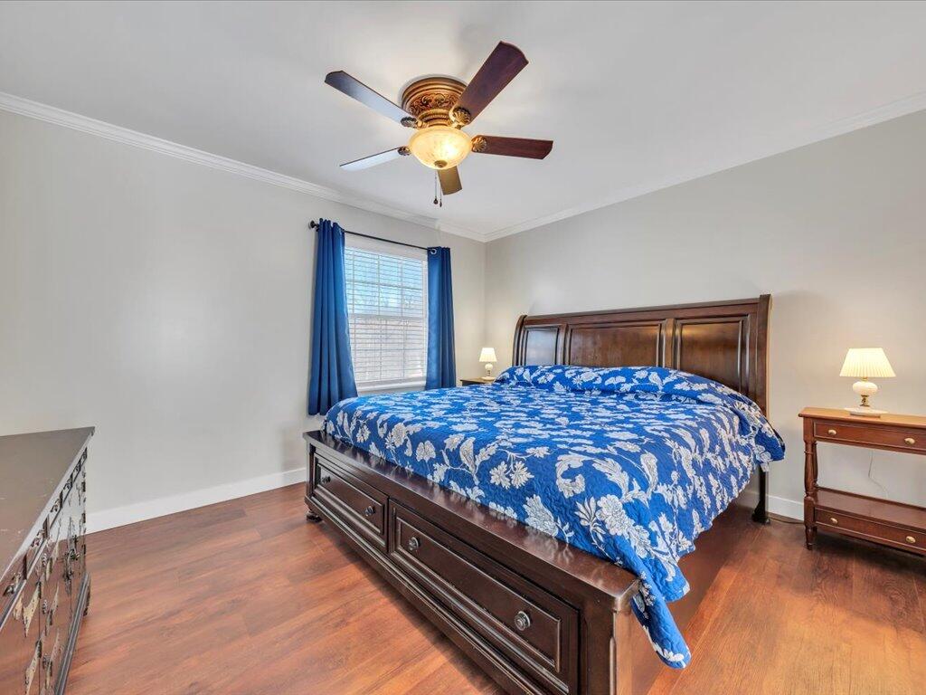 1511 Eggleston Falls Road Ridgeway, VA 24148 - Photo 30 of 151 a bedroom with a bed next to a window and a chandelier