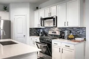 a kitchen with a sink a stove and cabinets