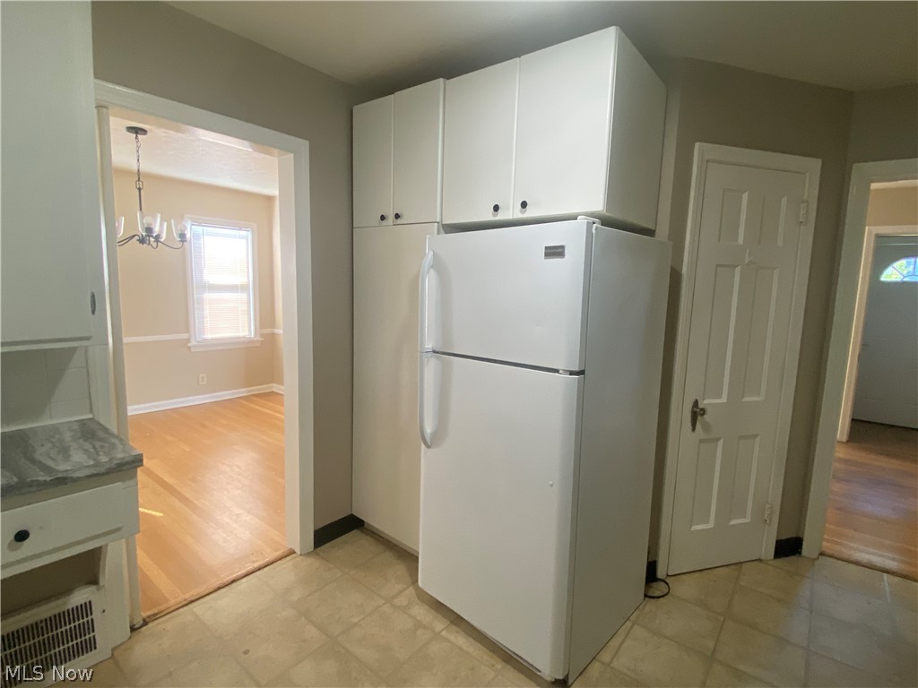 4218 Silsby Road University Heights, OH 44118 - Photo 9 of 27 Kitchen featuring built-in cabinetry, tiled flooring, and a white refrigerator
