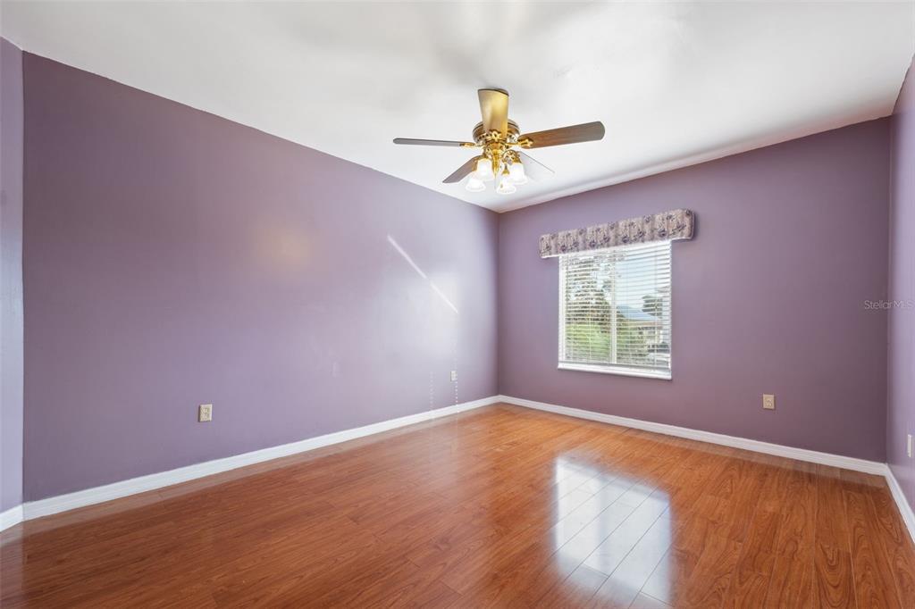 6225 Bayside Drive New Port Richey, FL 34652 - Photo 26 of 84 a view of room with hardwood floor and ceiling fan