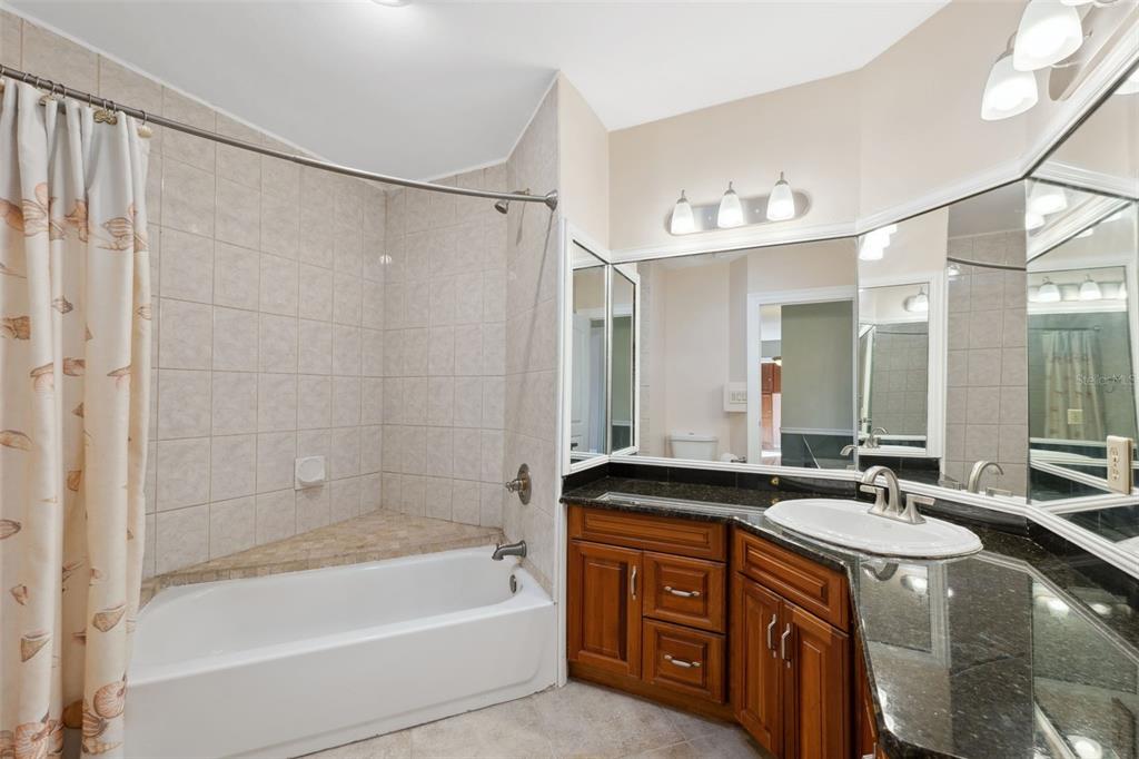 6225 Bayside Drive New Port Richey, FL 34652 - Photo 28 of 84 a bathroom with a tub a sink double vanity and shower
