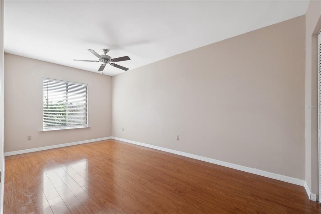 6225 Bayside Drive New Port Richey, FL 34652 - Photo 30 of 84 an empty room with wooden floor fan and windows