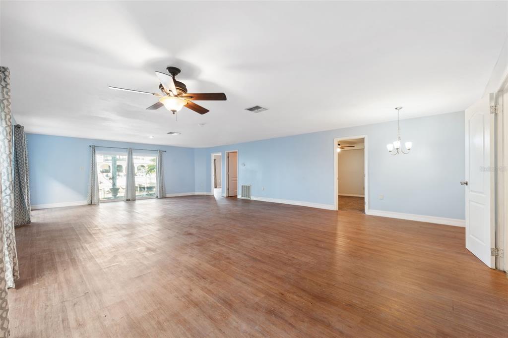 6225 Bayside Drive New Port Richey, FL 34652 - Photo 37 of 84 a view of a livingroom with a ceiling fan and wooden floor