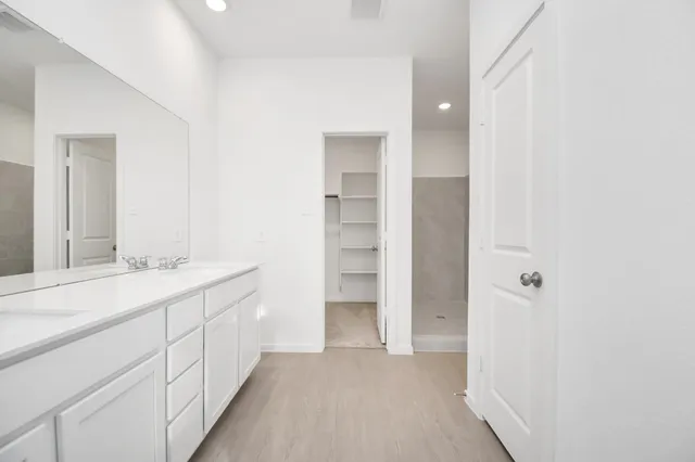a bathroom with a double vanity sink a and a mirror