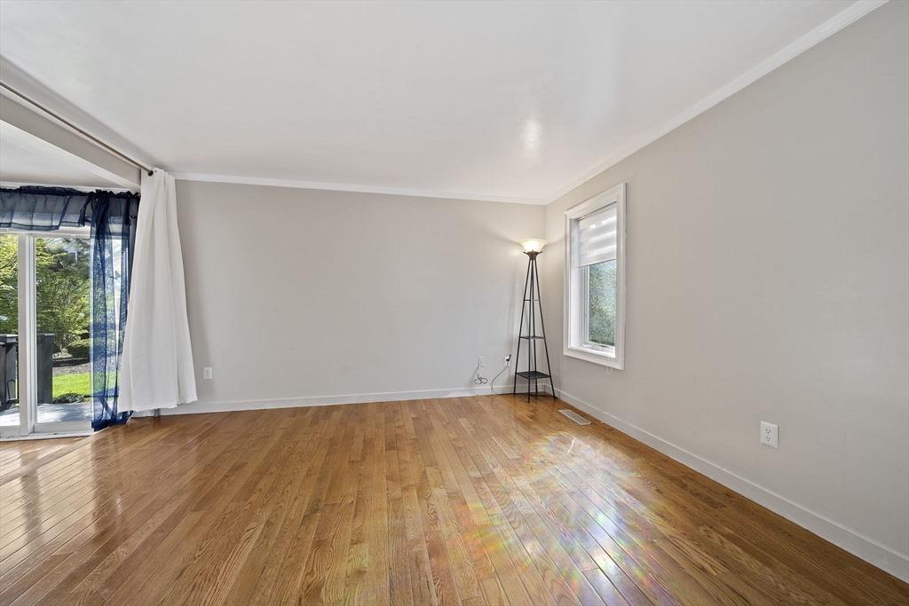 20 Jasper Lane, Unit 20 Randolph, MA 02368 - Photo 11 of 13 a view of an empty room with wooden floor and a window