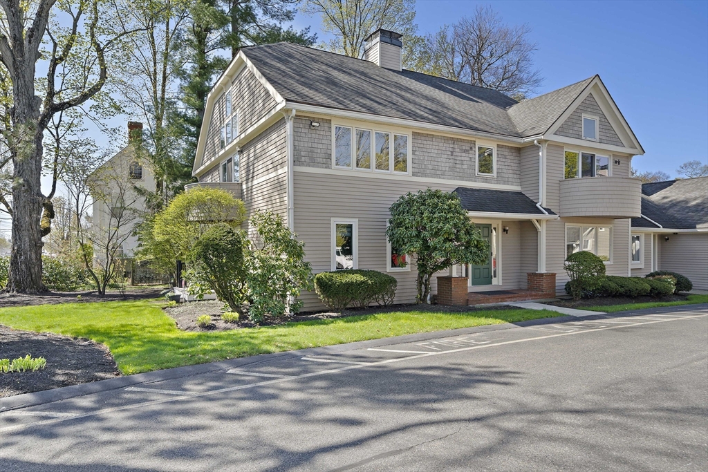 20 Jasper Lane, Unit 20 Randolph, MA 02368 - Photo 2 of 13 a front view of a house with a yard and garage