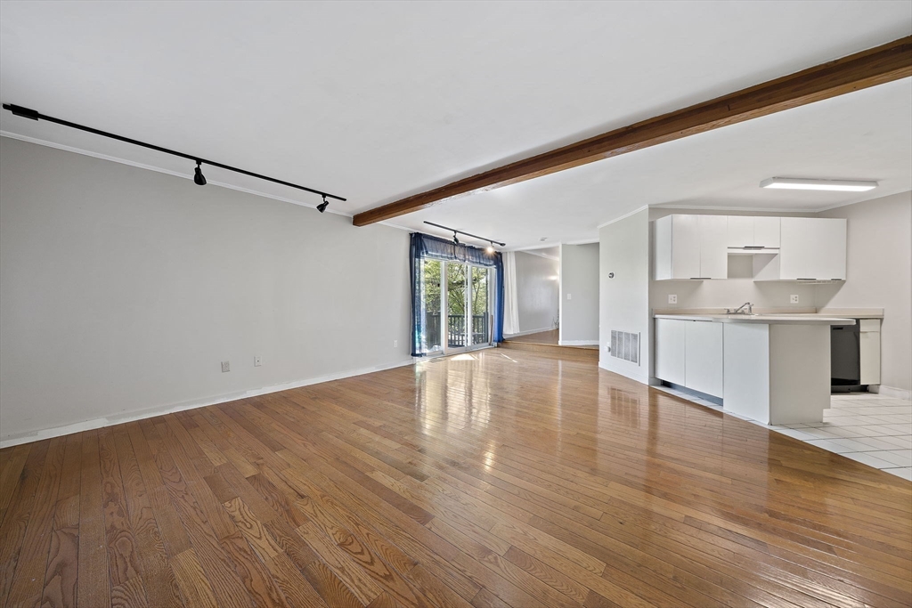 20 Jasper Lane, Unit 20 Randolph, MA 02368 - Photo 4 of 13 a view of an empty room with window and wooden floor