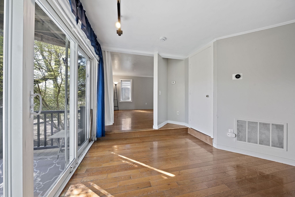 20 Jasper Lane, Unit 20 Randolph, MA 02368 - Photo 6 of 13 a view of a hallway with wooden floor and a living room