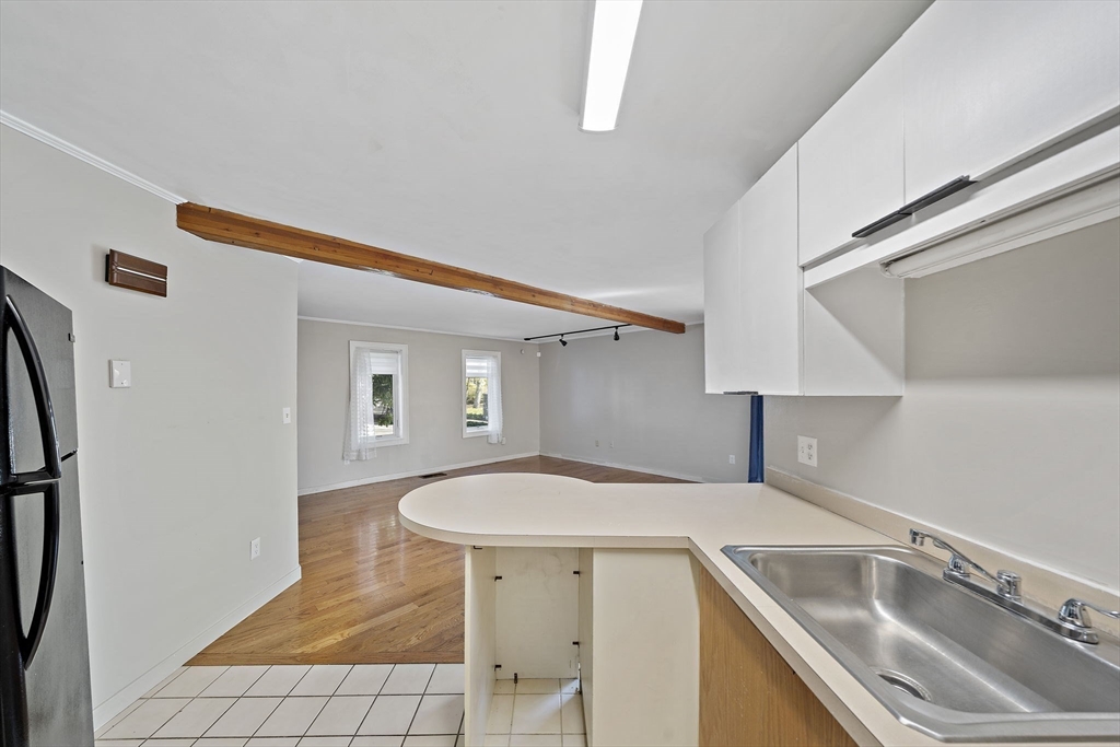 20 Jasper Lane, Unit 20 Randolph, MA 02368 - Photo 10 of 13 a kitchen with a sink a refrigerator and cabinets