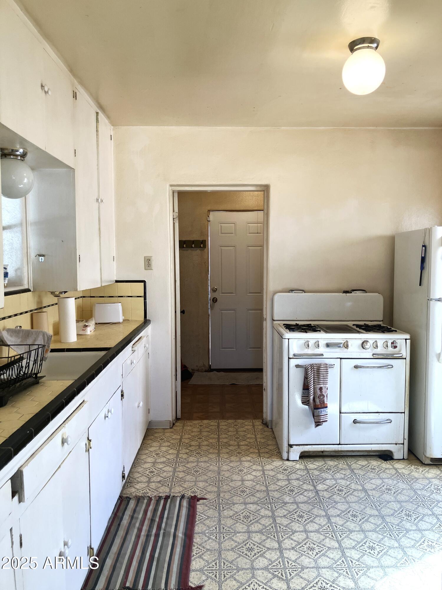 1637 East Roma Avenue Phoenix, AZ 85016 - Photo 24 of 78 a large kitchen with a stove and a sink