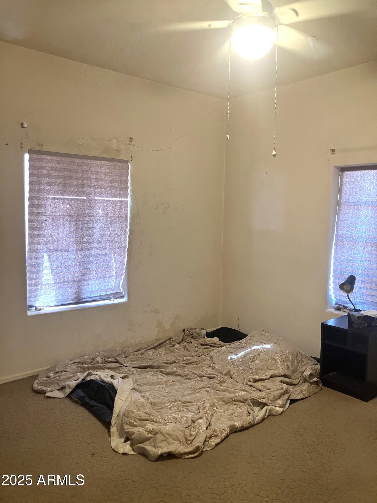 1637 East Roma Avenue Phoenix, AZ 85016 - Photo 39 of 78 a bed sitting in a bedroom next to a window