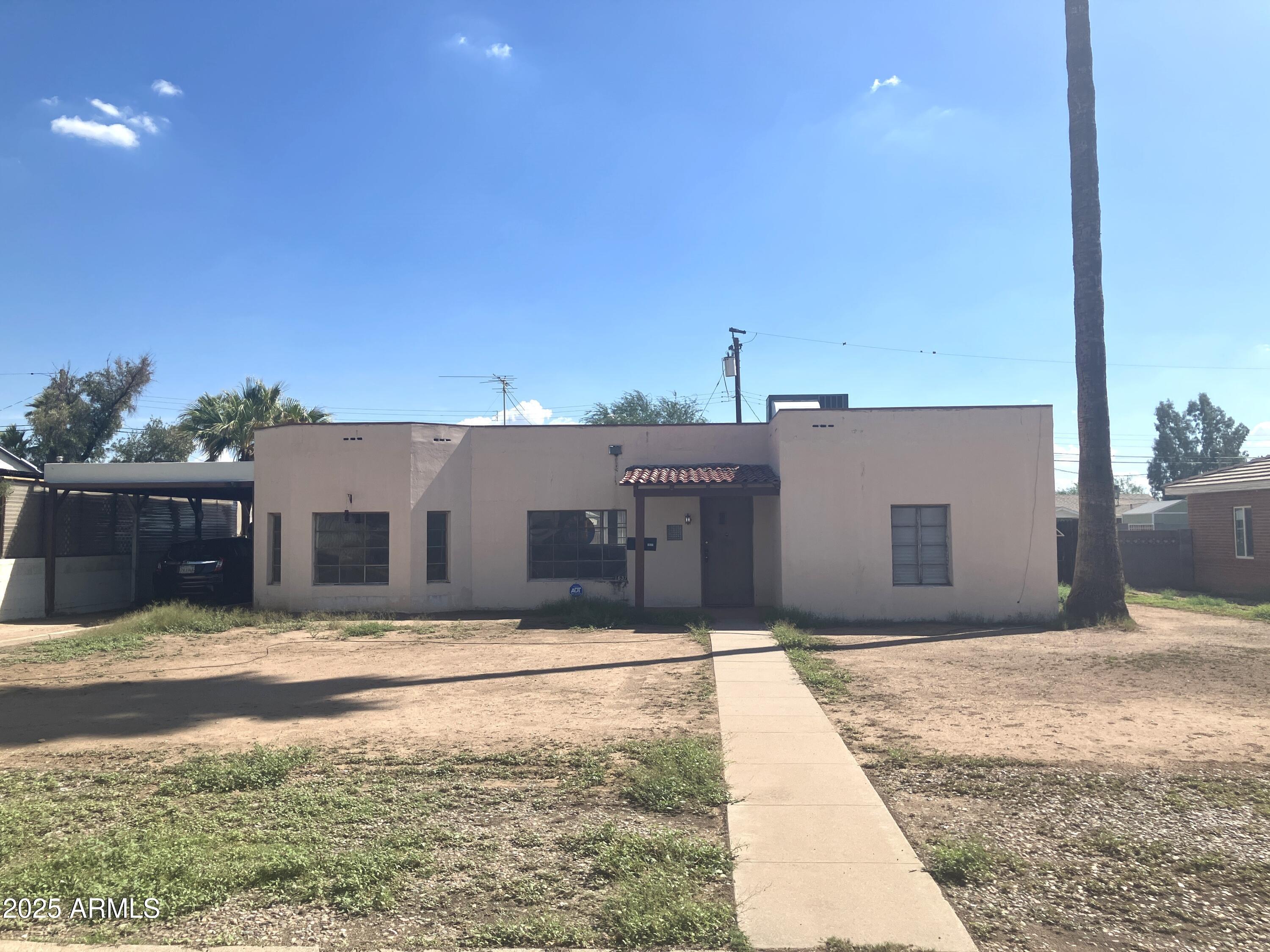 1637 East Roma Avenue Phoenix, AZ 85016 - Photo 3 of 78 a front view of a house with a yard