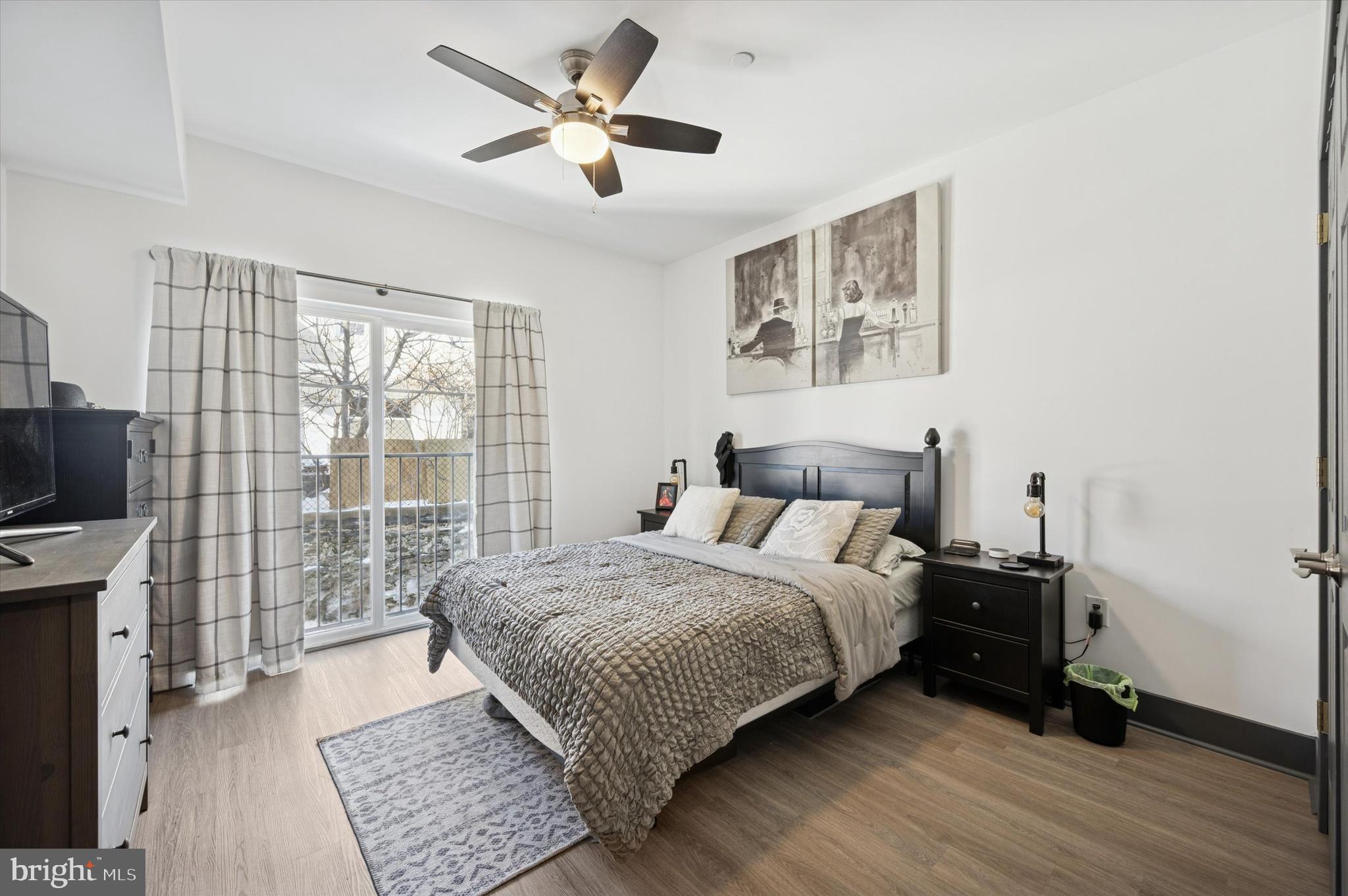 124-26 Levering Street, Unit 2A Philadelphia, PA 19127 - Photo 7 of 18 a bedroom with a large bed and a tv