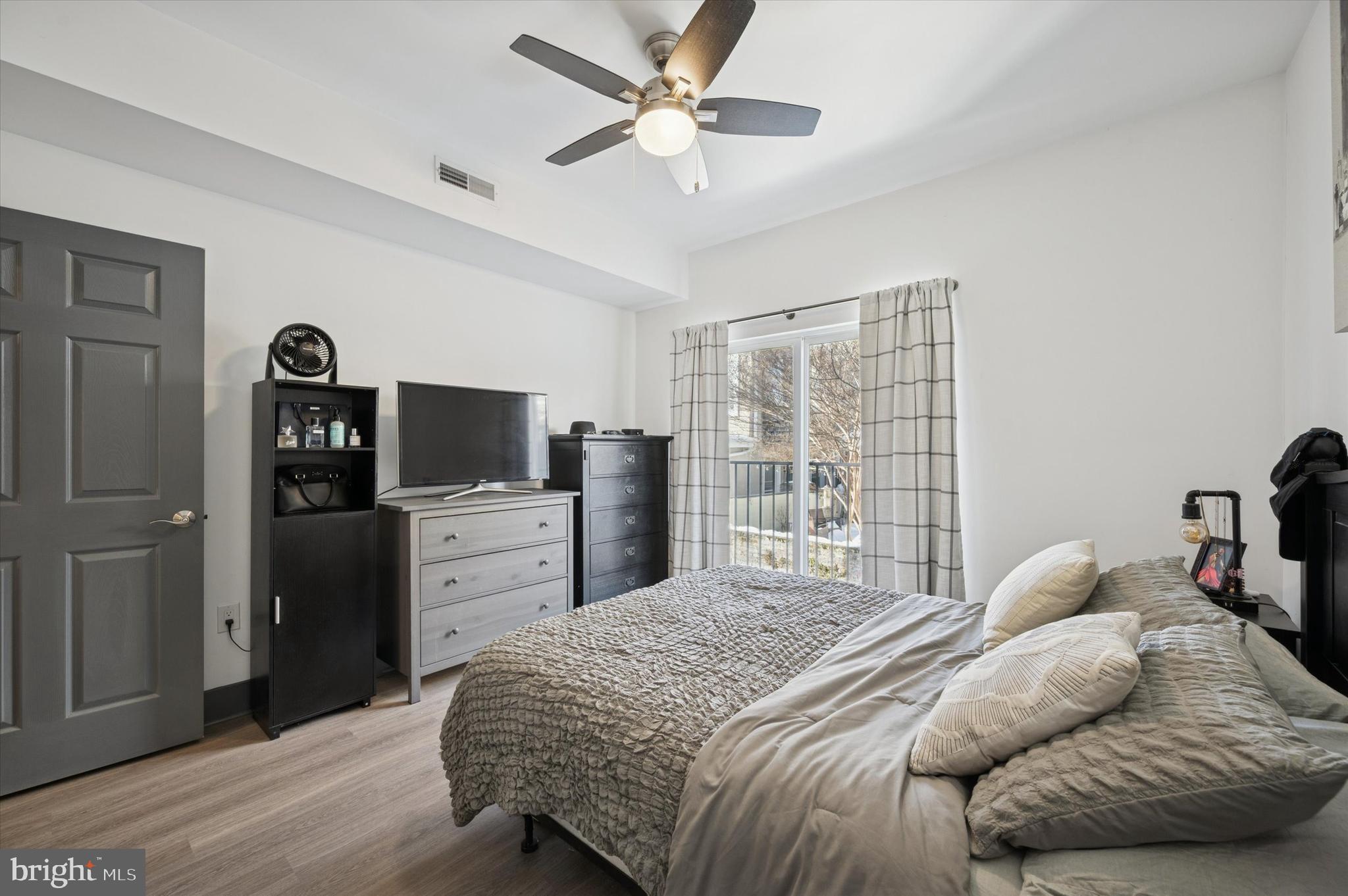 124-26 Levering Street, Unit 2A Philadelphia, PA 19127 - Photo 8 of 18 a bedroom with a bed and a television