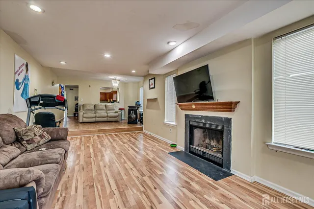 a living room with furniture a fireplace and a flat screen tv