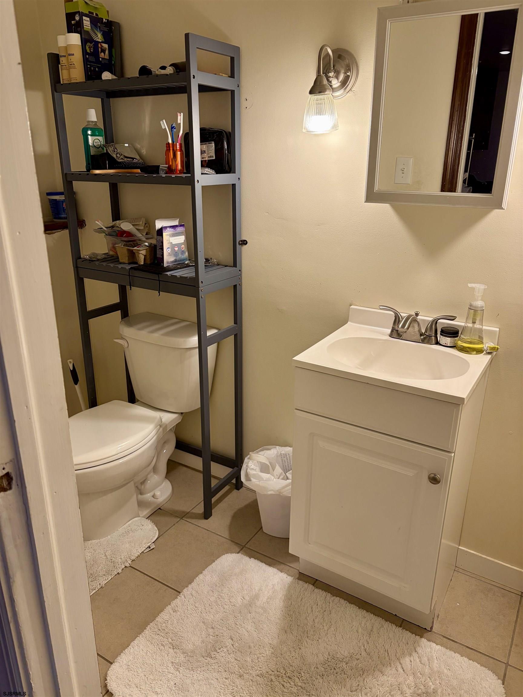 155 Chestnut Street Woodbine, NJ 08270 - Photo 13 of 18 a bathroom with a toilet a sink and a mirror