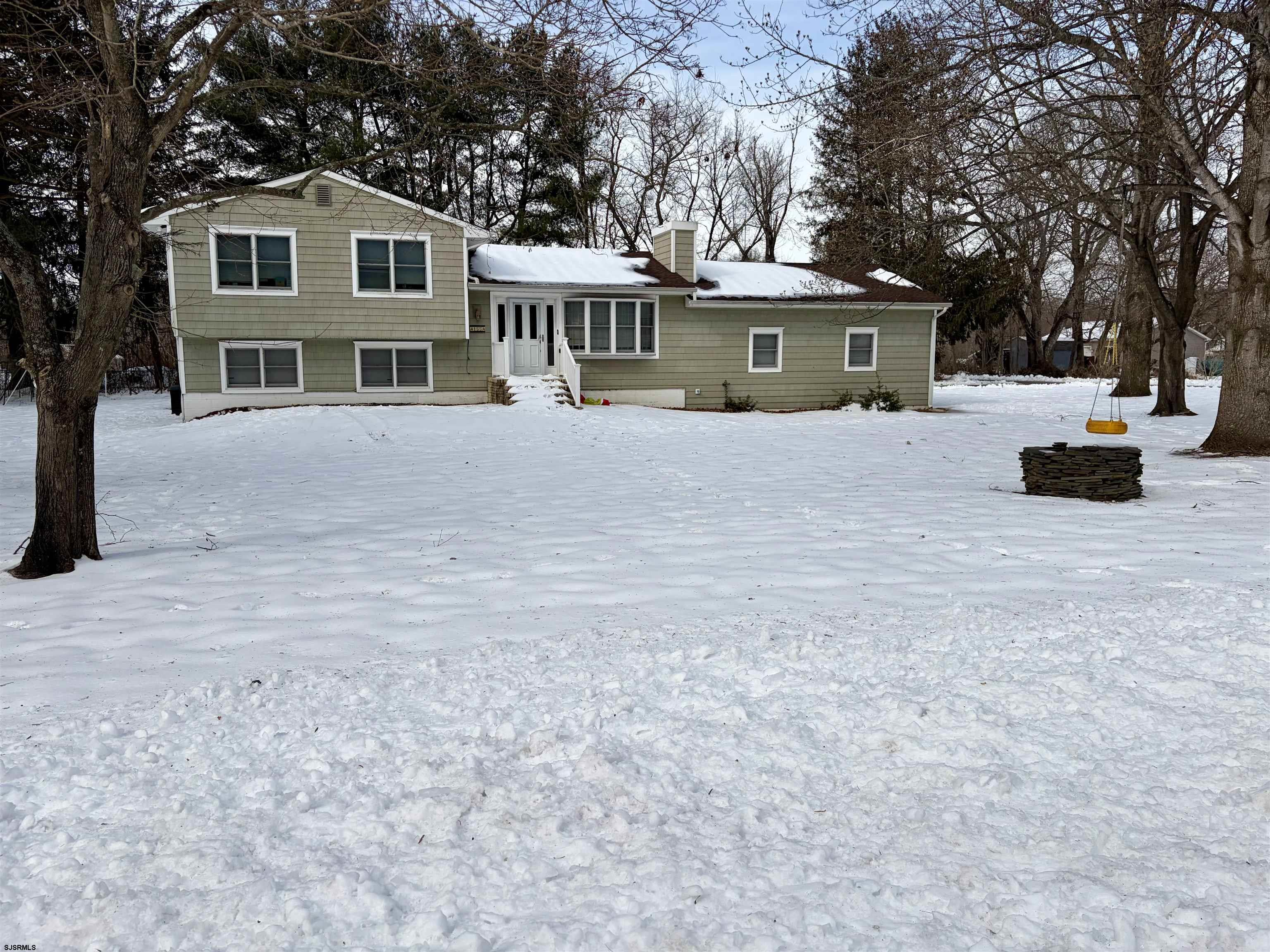 155 Chestnut Street Woodbine, NJ 08270 - Photo 3 of 18 a front view of a house with a yard and large trees