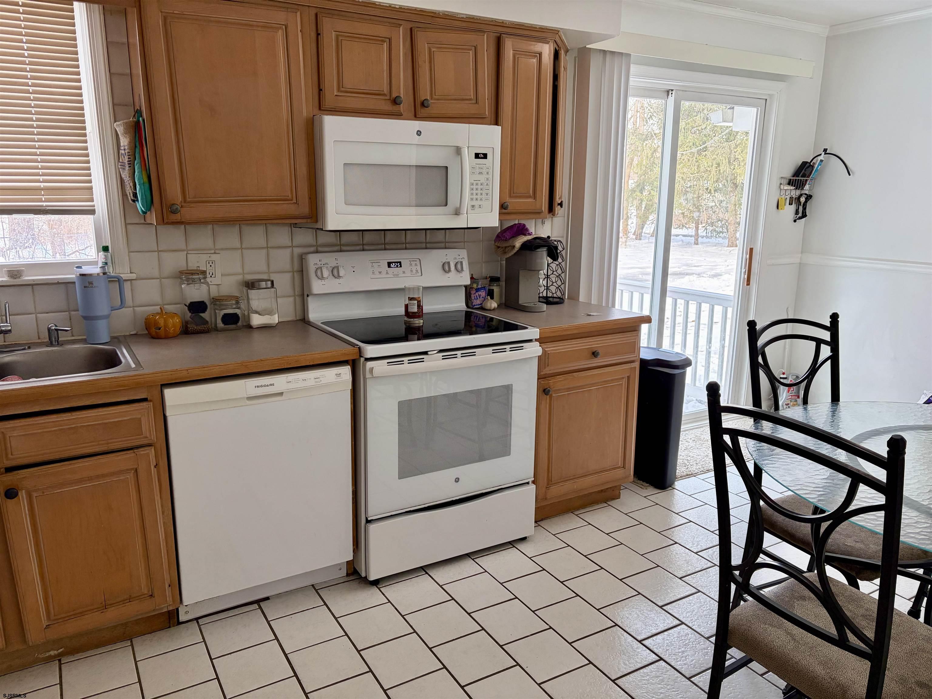 155 Chestnut Street Woodbine, NJ 08270 - Photo 9 of 18 a kitchen with a stove a sink and a microwave