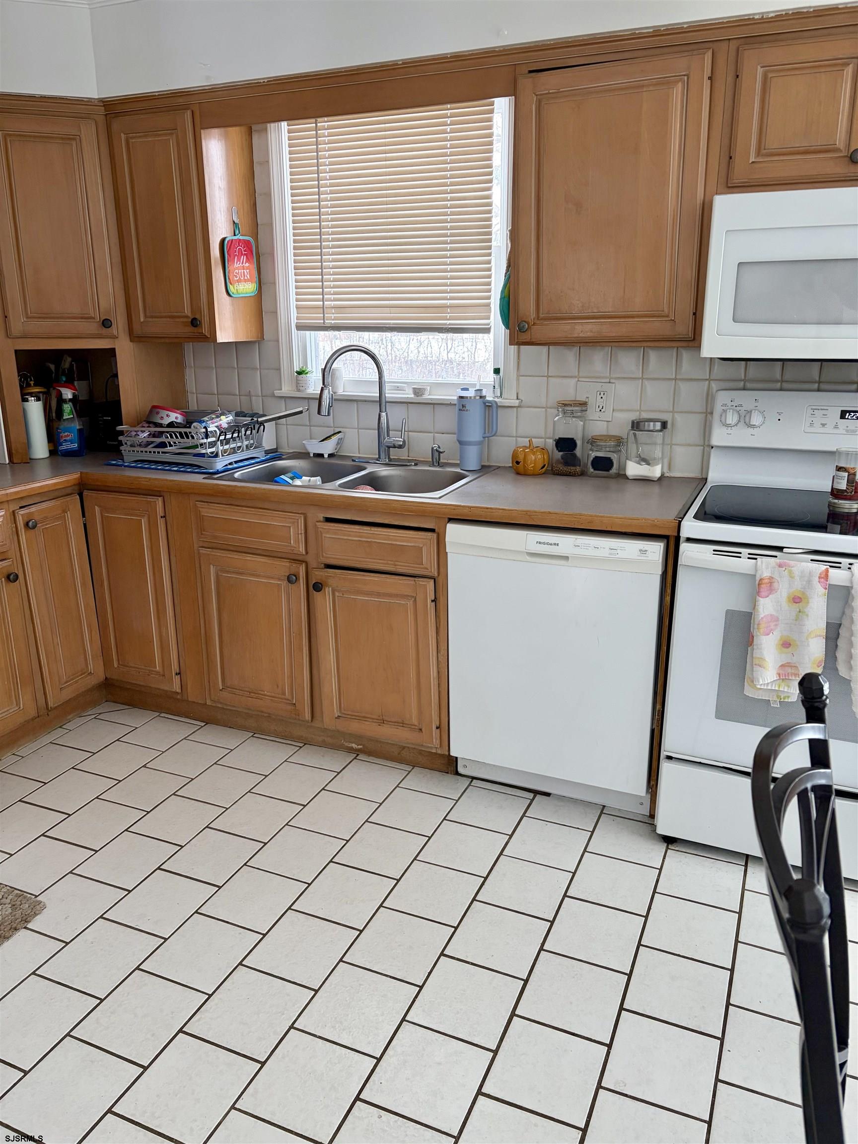 155 Chestnut Street Woodbine, NJ 08270 - Photo 10 of 18 a kitchen with stainless steel appliances a sink window and cabinets