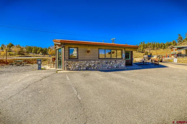 a view of a house with wooden fence