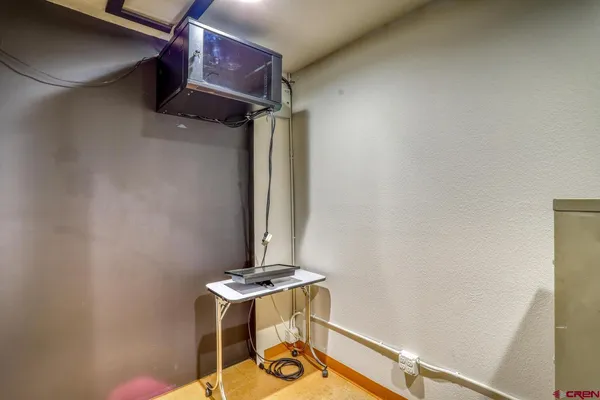 a view of a porch with a table and chairs
