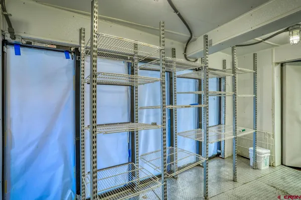a view of a hallway with livingroom and furniture