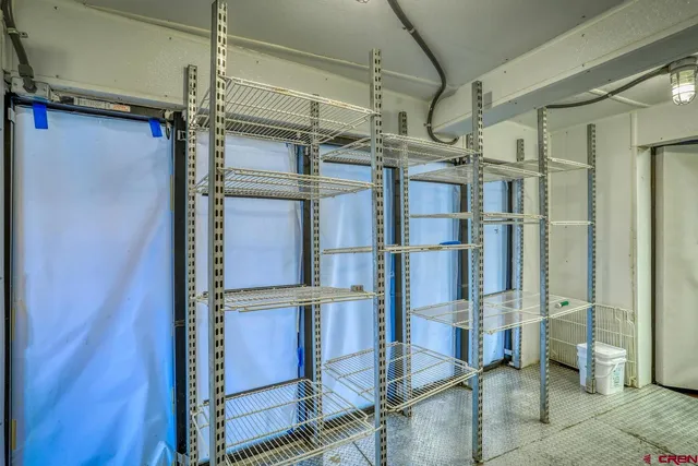 a view of a hallway with livingroom and furniture