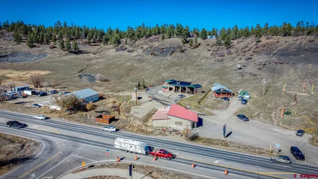 an aerial view of a house with a mountain