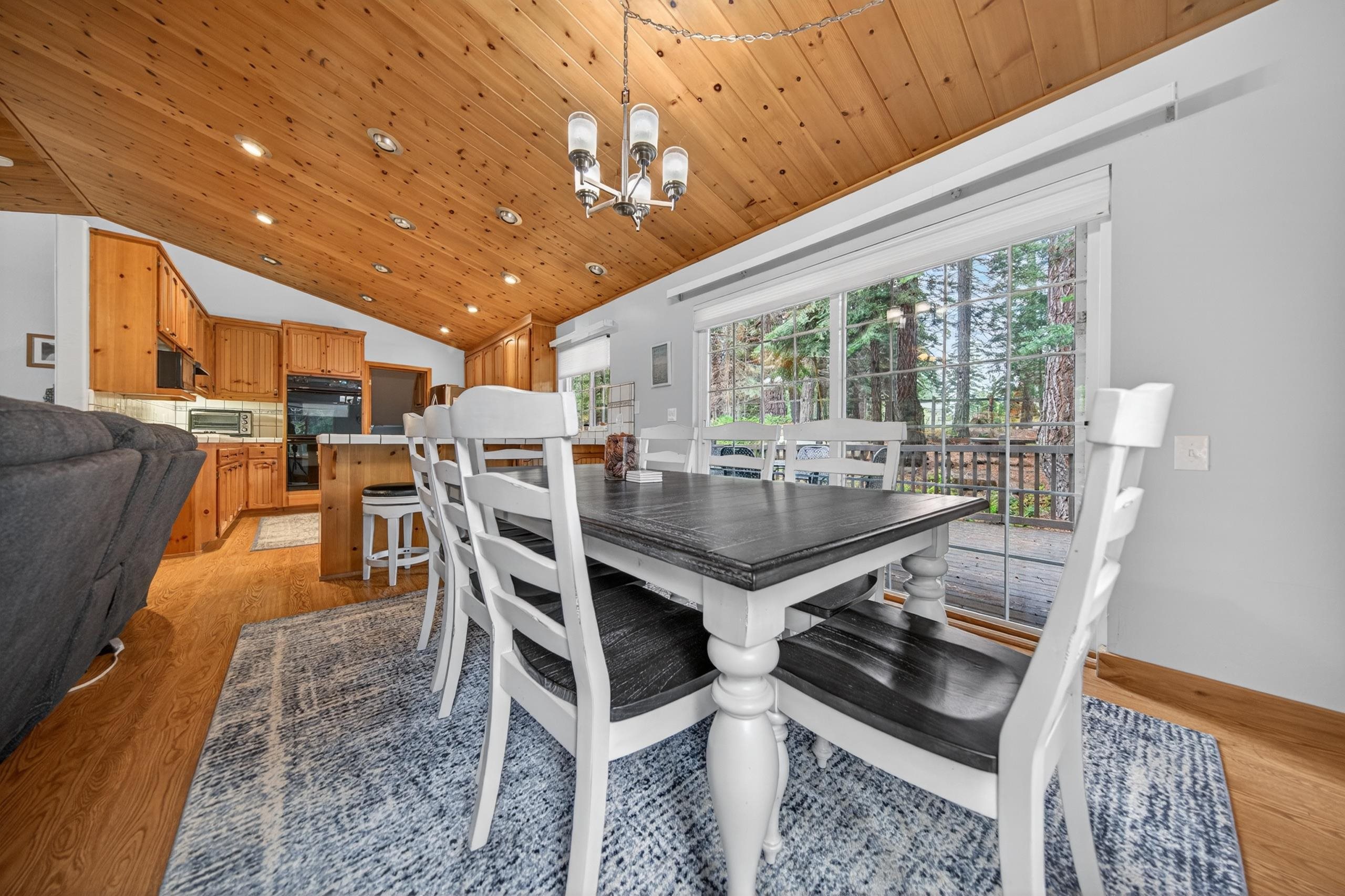 1220 Lynx Road Lake Almanor, CA 96137 - Photo 14 of 45 a dining room with furniture and a floor to ceiling window