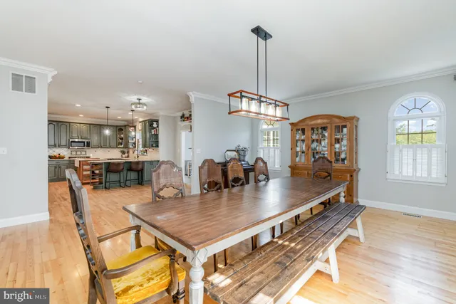 a living room with furniture a large window and a chandelier