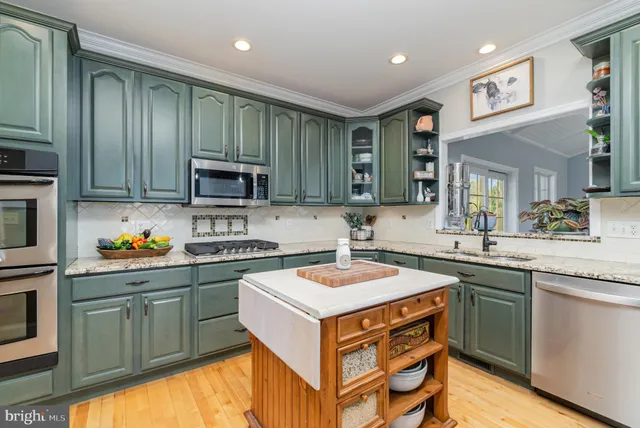 a living room with furniture a flat screen tv and a table