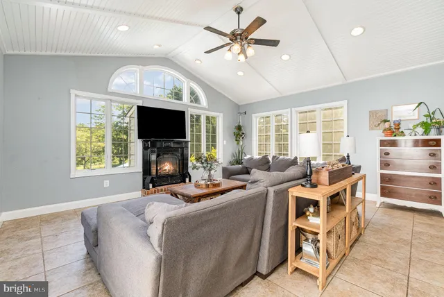 a bathroom with a granite countertop sink a mirror and shower