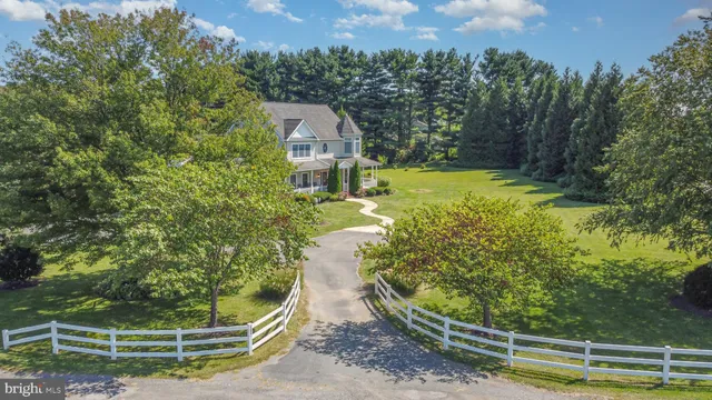 a view of a house with a yard and a fountain