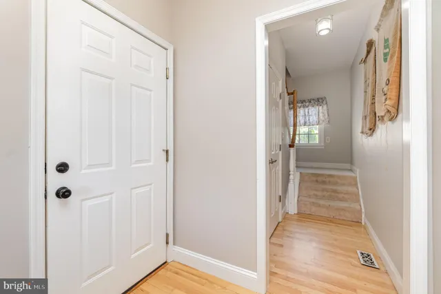 an empty room with a window and closet area