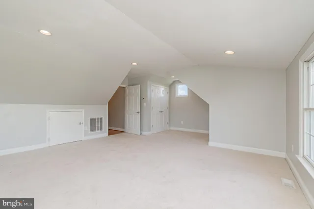 an aerial view of a house with a yard and lake view