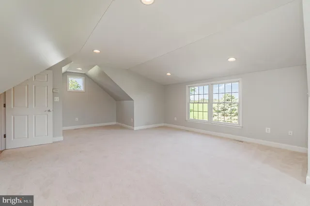 aerial view of a house with pool garden and lake view