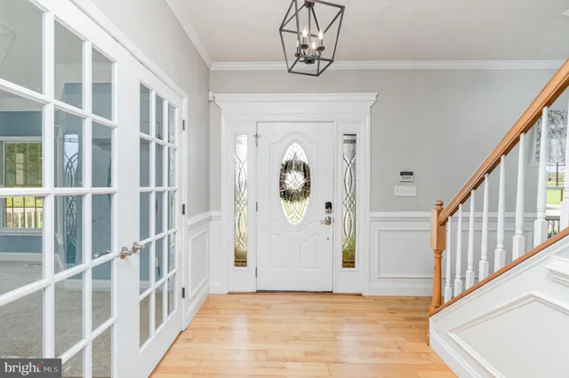 a dining room with stainless steel appliances kitchen island granite countertop a sink and cabinets
