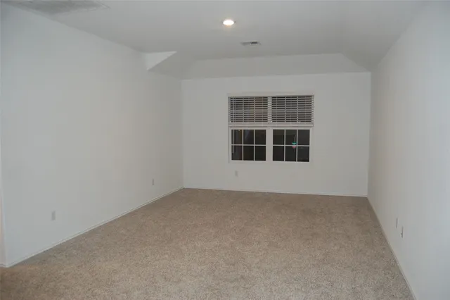 a view of kitchen with microwave and refrigerator