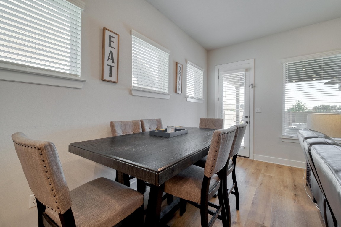 1113 Dog Iron Street Georgetown, TX 78633 - Photo 14 of 33 a view of a dining room with furniture and wooden floor