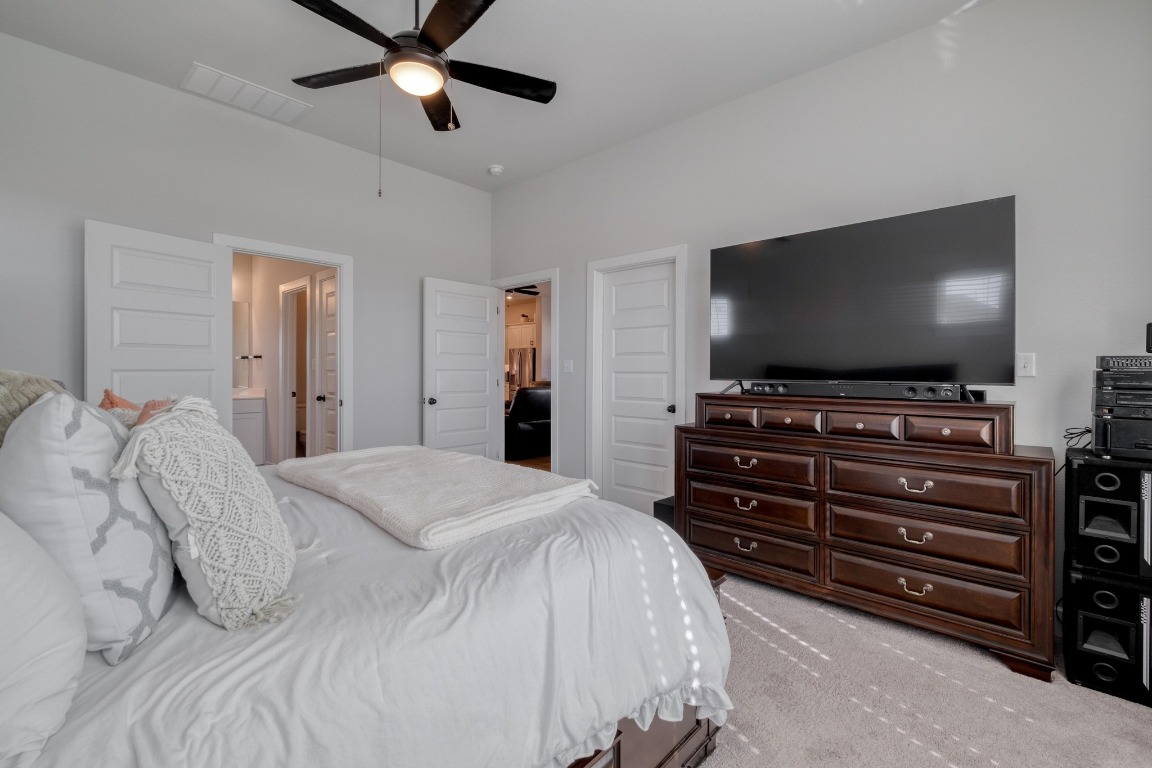 1113 Dog Iron Street Georgetown, TX 78633 - Photo 17 of 33 a bedroom with a bed and a flat screen tv